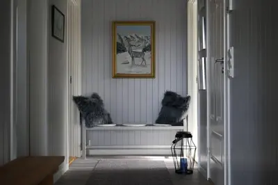 a hallway with a window and a picture on the wall at Luxury Norwegian Cottage in Hurdal