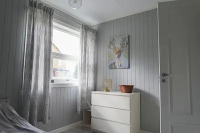 a room with a dresser and a window and a dresser at Luxury Norwegian Cottage in Hurdal