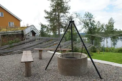 a playground with a bench and a bucket at Luxury Norwegian Cottage in Hurdal