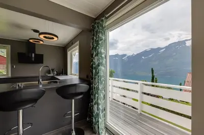 a kitchen with a sink and a large window at Flotunet - Jørnhuset in Stryn