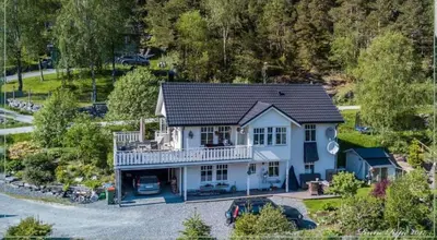an aerial view of a blue house with a balcony at Between Fjord og Glacier in Ålfoten