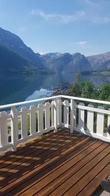 a wooden deck with a view of a lake at Between Fjord og Glacier in Ålfoten