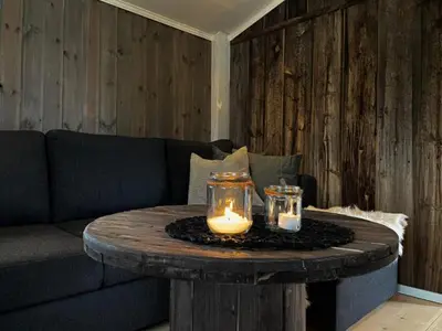 a coffee table with two candles on top of it at Stall-loftet, Aastrøen gård, Vingelen in Vingelen