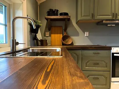 a kitchen with a sink and a wooden counter top at Stall-loftet, Aastrøen gård, Vingelen in Vingelen