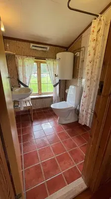 a bathroom with a tub and a toilet and a sink at Gammelstua ved Femund in Elga