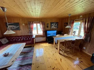 a living room with a couch and a table at Gammelstua ved Femund in Elga