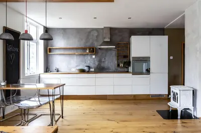 a kitchen with white cabinets and a table at Cozy apartment in Alesund city in Ålesund