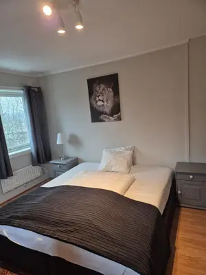 a bedroom with a bed with a lion picture on the wall at Utleiebolig Fannrem in Fannrem