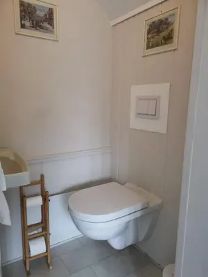 a white bathroom with a toilet and a sink at Utleiebolig Fannrem in Fannrem