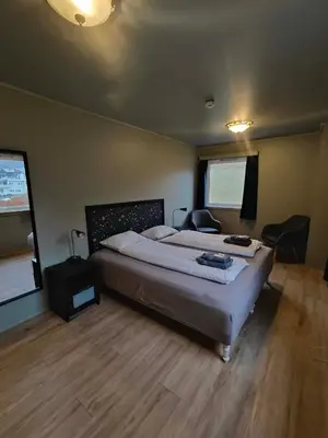 a bedroom with a large bed in a room at Gjøa Motell in Rosendal