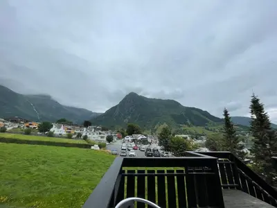 a view of a town with cars driving down a road at Gjøa Motell in Rosendal