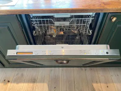 a dishwasher with a dish rack in it at Løstegård Cabins in Gol