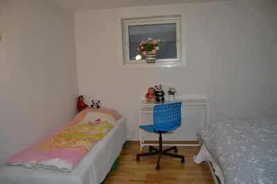 a bedroom with a bed and a chair next to a desk at Totally independent apartment near NTNU,Lerkendal and Center in Trondheim
