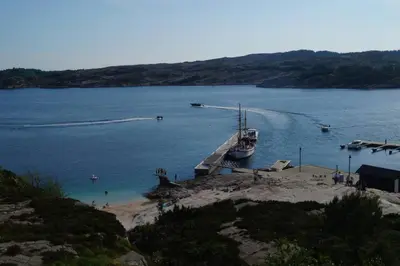 a boat is docked at a dock in the water at Austefjordtunet 15 in Forland