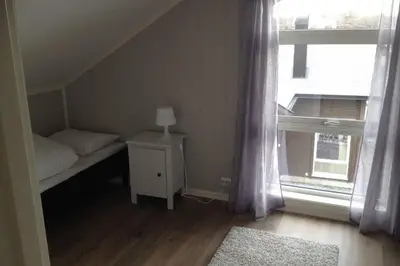 a small bedroom with a bed and a window at Austefjordtunet 15 in Forland