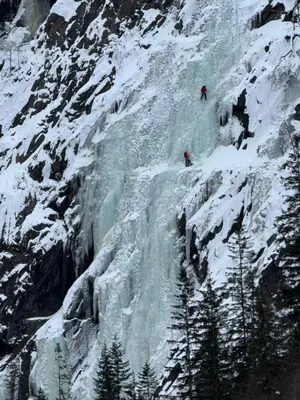 two people are climbing a snow covered mountain at Villa Rjukan in Rjukan