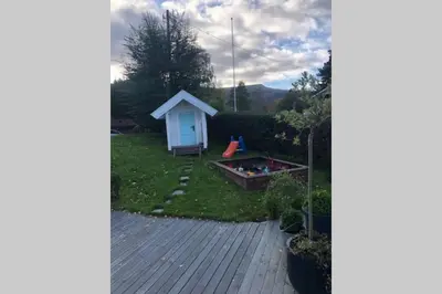 a view of a backyard with a dog house at Koselig garasjeloft! in Holen