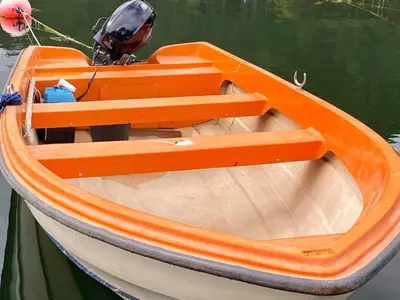 an orange boat sitting in the water at 4 person holiday home in Reksteren-By Traum in Klinkholmen