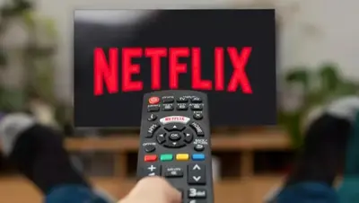 a person holding a remote control with the word netflix at Fantastic and high standard apartment in Nordseter in Lillehammer