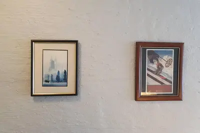 two pictures hanging on a white wall at Fantastic and high standard apartment in Nordseter in Lillehammer