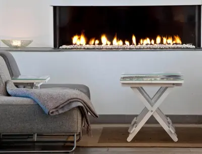 a living room with a couch and a fireplace at Lillehammer Hostel in Lillehammer