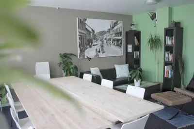 a living room with a wooden table and a couch at Lillehammer Hostel in Lillehammer