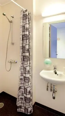 a bathroom with a sink and a shower at Lillehammer Hostel in Lillehammer