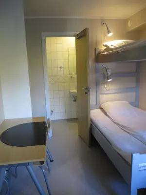 a small room with a bed and a bathroom at Hamar Vandrerhjem in Hamar