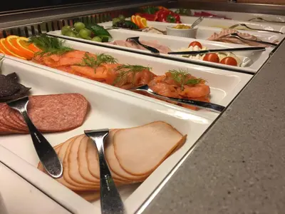 a buffet with several trays of different types of food at Hamar Vandrerhjem in Hamar