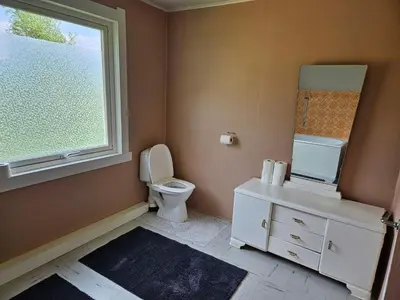 a bathroom with a toilet and a sink and a window at 6 person holiday home in FISKÅ-By Traum in Fiskå