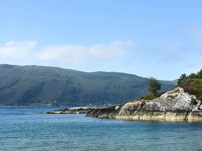 a large body of water with mountains in the background at 6 person holiday home in FISKÅ-By Traum in Fiskå
