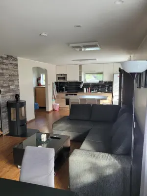 a living room with a couch and a kitchen at Espeland in Bergen