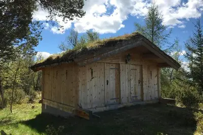 a wooden shed with a grass roof at Fjellro Mountain Cabin in Oppdal