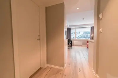 an empty hallway with a room with a window at Ustedalen Resort Leiligheter in Geilo