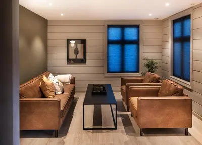 a living room with two couches and a coffee table at Godo Lodge in Godøy
