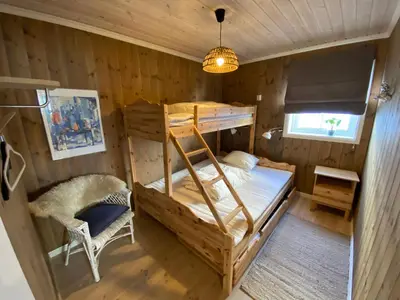 a bedroom with a bunk bed and a chair at Endely - ski inn / ut in Rauland