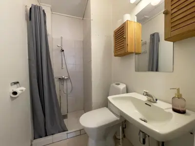 a bathroom with a sink and a toilet and a shower at BORG Sommerhotell in Ålesund