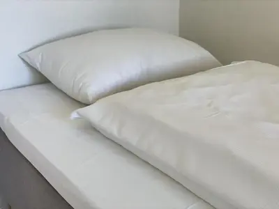 two white pillows sitting on top of a bed at BORG Sommerhotell in Ålesund
