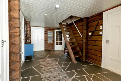 a hallway with wooden walls and stairs in a house at Utsikten in Sykkylven