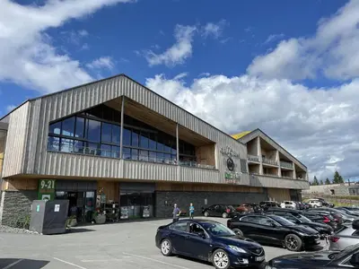 a parking lot with cars parked in front of a building at Large cabin at Sjusjøen with sauna, fireplace, view and cross-country skiing in Ringsaker