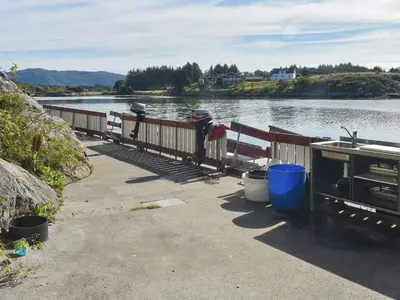 a dock with a boat on the water at 6 person holiday home in Bud-By Traum in Bud