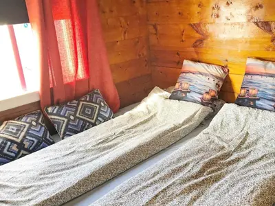 a bed in a room with two pillows on it at 6 person holiday home in Utvik in Utvik