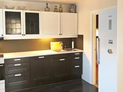 a kitchen with black and white cabinets and a sink at 6 person holiday home in Utvik in Utvik