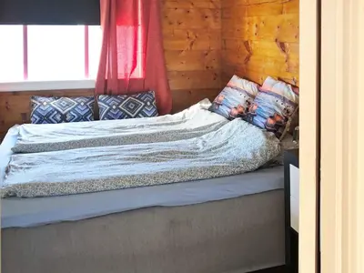 a bed with pillows on it in a room at 6 person holiday home in Utvik in Utvik