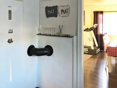 a door with a black door knocker on a wall at 6 person holiday home in Utvik in Utvik