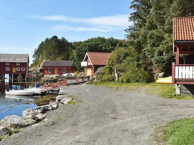 a dirt road next to a river with houses at 6 person holiday home in Bud-By Traum in Bud