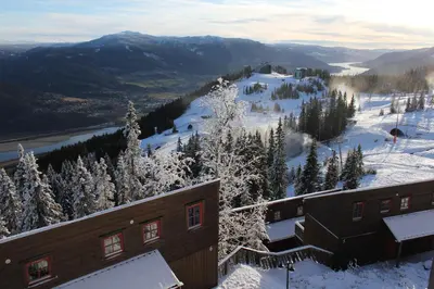 a view of a snow covered mountain with a building at Kvitfjell Alpinhytter Kvitfjellvegen 492 in Kvitfjell