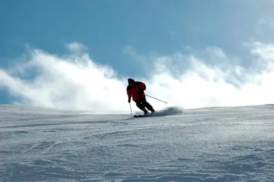 a man is skiing down a snow covered slope at Kvitfjell Alpinhytter Kvitfjellvegen 492 in Kvitfjell
