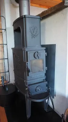 an old woodburning stove sitting in a room at Klævold utleigehytte in Klevoll