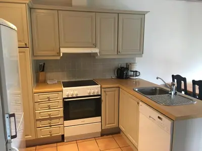 a kitchen with a sink and a stove top oven at Øen Turistsenter Apartments in Geilo